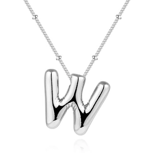 Macro detail of silver bubble letter W pendant on a thin stainless steel chain