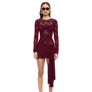 Detail of burgundy lace mini dress featuring sheer long sleeves and side ribbon ties