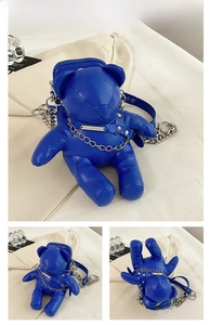 Close-up of the bright blue bear-shaped PU leather bag with silver metal chain straps
