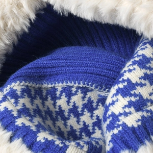 Winter knit fisherman hat with houndstooth pattern and thick white faux fur trim
