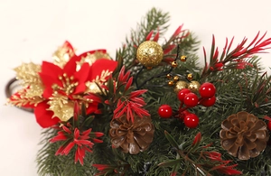 Detail of Christmas teardrop swag with red poinsettia, pine cones, and gold ornaments