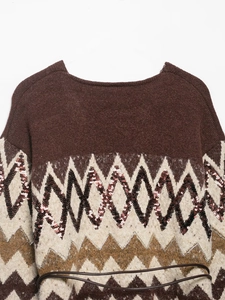 Detail of vintage knit cardigan with sequined wave patterns and adjustable waist belt