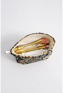 Detail showing inner beige canvas lining of the large capacity floral makeup bag