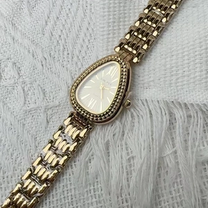 Detailed view of the luxury gold serpent watch dial featuring a quartz movement display