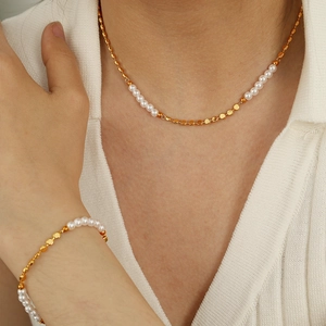Elegant gold chain necklace and bracelet set with freshwater pearls on model