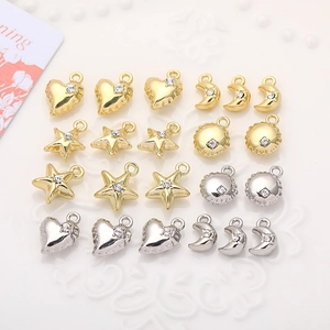 Detailed view of mini heart, star and moon alloy charms with rhinestones in gold and silver