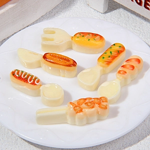 6-piece miniature cutlery set with food-shaped resin handles on a white round plate