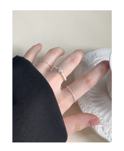 Detail showing S925 silver beaded pearl ring and slim bands layered on a hand