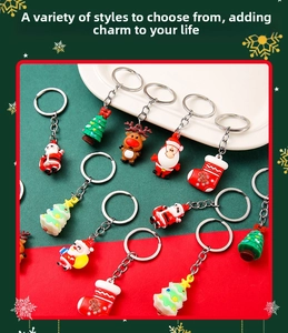 Close-up of silicone Christmas keychains with Santa Claus and reindeer on a ceramic tray
