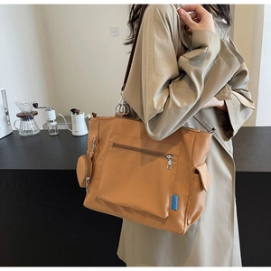 Close-up of khaki Oxford tote bag with front zipper pocket and detachable coin purse