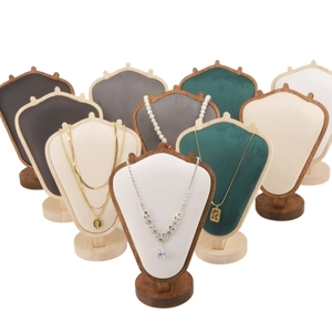 Detail of assorted velvet necklace display stands with wooden bases in multiple colors