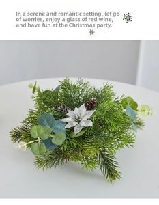 Top view of a mini Christmas tree pot with pine cones, pine needles and white silk flowers