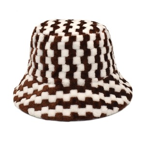 Detail of the soft faux fur texture and brown checkerboard pattern on the bucket hat