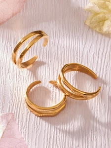 Detailed view of three-piece gold stacked rings with double-layer open design on petals