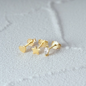 Close-up of gold-plated S925 silver stud earrings set with heart and star zircon