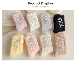 Detailed flat lay of eight soft coral fleece socks with ribbon bow tie decorations