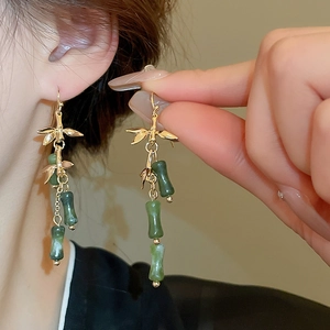 Bamboo style gold tassel earrings with green faux jade stones for a classic Chinese aesthetic