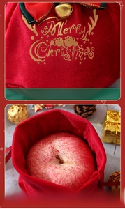 Close-up of velvet Christmas gift bag with gold Merry Christmas print and bow detail