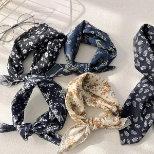 Flat lay of vintage floral cotton linen scarves with elegant leaf patterns and accessories