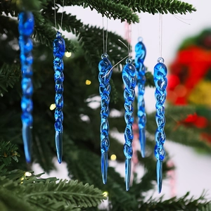 Detailed view of blue transparent spiral icicle ornaments hanging on a Christmas tree