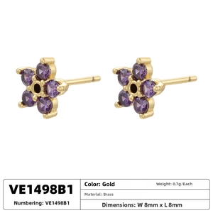 Detail of 8mm gold brass flower stud earrings with purple cubic zirconia stones