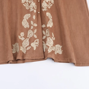 Brown suede shirt dress featuring vintage floral embroidery and golden round buttons