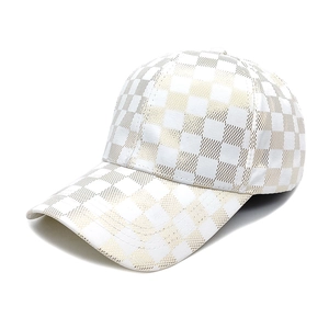 Detailed close-up of white and gold checkered baseball cap with fine double stitching
