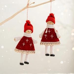 Handmade Christmas Santa and girl plush ornaments hanging on tree branch with festive decor