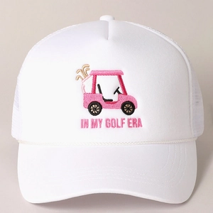 White trucker hat with pink IN MY GOLF ERA embroidery and golf cart graphic