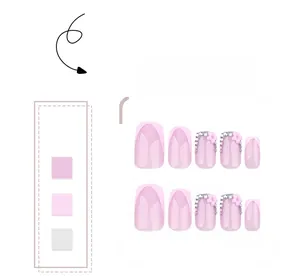 Detail of pink French manicured press-on nails with 3D resin flowers, pearls and rhinestones