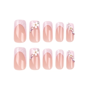 Pink French square press-on nails with 3D white flowers, glitter, and colorful rhinestones