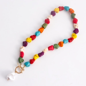 Detailed shot of multi-color stone beads necklace with gold OT buckle and baroque pearl