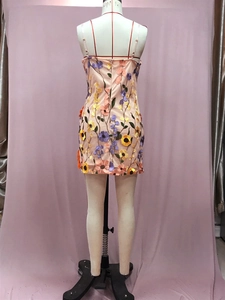 Detail der 3D-Blumenstickerei und Netznähte am eleganten apricotfarbenen Trägerkleid