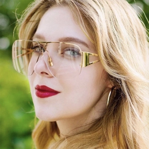 Close-up of gold metal pilot sunglasses with transparent lenses on female model