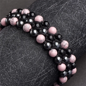 Close-up of triple-layer braided bracelet with pink turquoise and black hematite beads