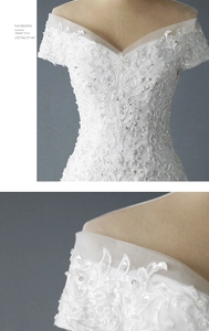 Détail de robe de mariée à épaules dénudées avec dentelle florale et paillettes brillantes