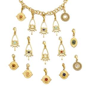 Flat lay of gold evil eye pendants with colorful stones on a stainless steel necklace