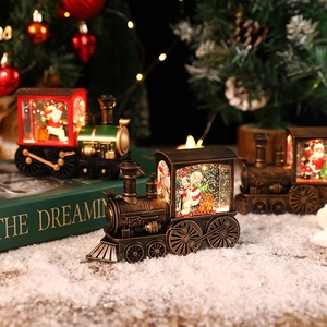 Christmas train snow globe lanterns with Santa and snowman figures in warm light