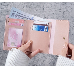 Pink trifold wallet interior showing card slots, ID window and large cash compartment