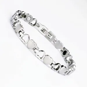 Detailed close-up of a stainless steel heart-shaped magnetic therapy bracelet with fold-over clasp