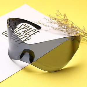 Detail view of oversized punk Y2K shield sunglasses on a textured yellow background