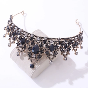 Macro detail of vintage gold headband featuring black water-drop crystals and rhinestones