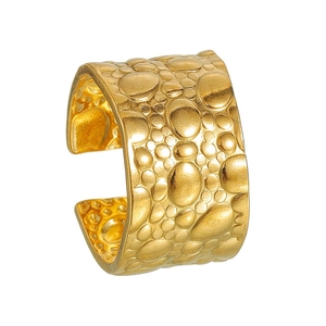 Detailed view of wide golden open ring with unique bubble textured finish on steel