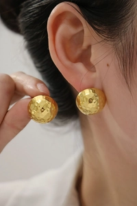 Detailed view of 18K gold-plated stainless steel stud earrings with hammered texture
