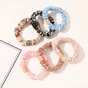 Close-up of 6-piece scrunchie set featuring satin textures, floral prints and leopard patterns