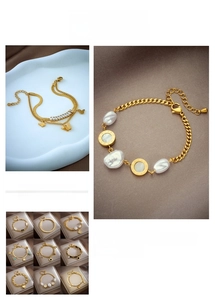 Detail of layered gold-plated chain bracelets with butterfly pendant and pearl accents
