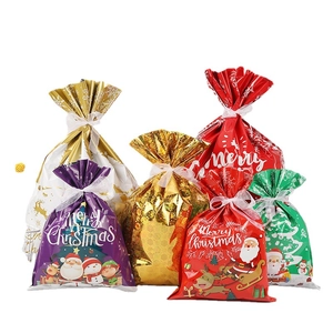 Christmas drawstring gift bag set with reindeer and Santa designs on metallic foil surface