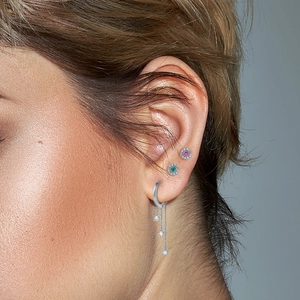 Detail of S925 silver hoop earring with tassel diamonds and colorful stud earrings