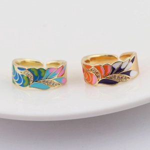 Close-up of gold-plated adjustable rings with colorful enamel painting and zircon inlay