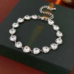 Detail of silver heart bracelet with colorful zircon stones and adjustable chain length